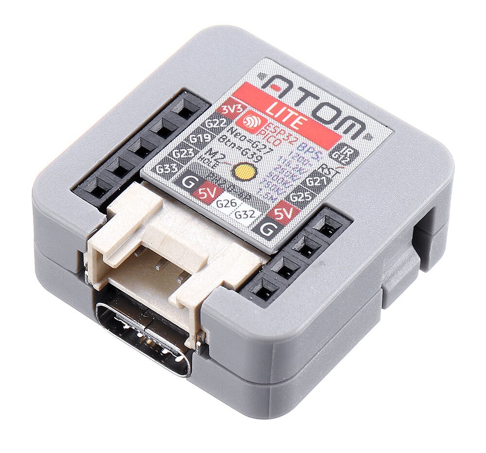 Photo of an M5Stack Atom Light. It is a small grey rectangular prism. There is a USB-C connector on one side, which is about one third of the width of that axis. There are some jumper sockets on the top surface.